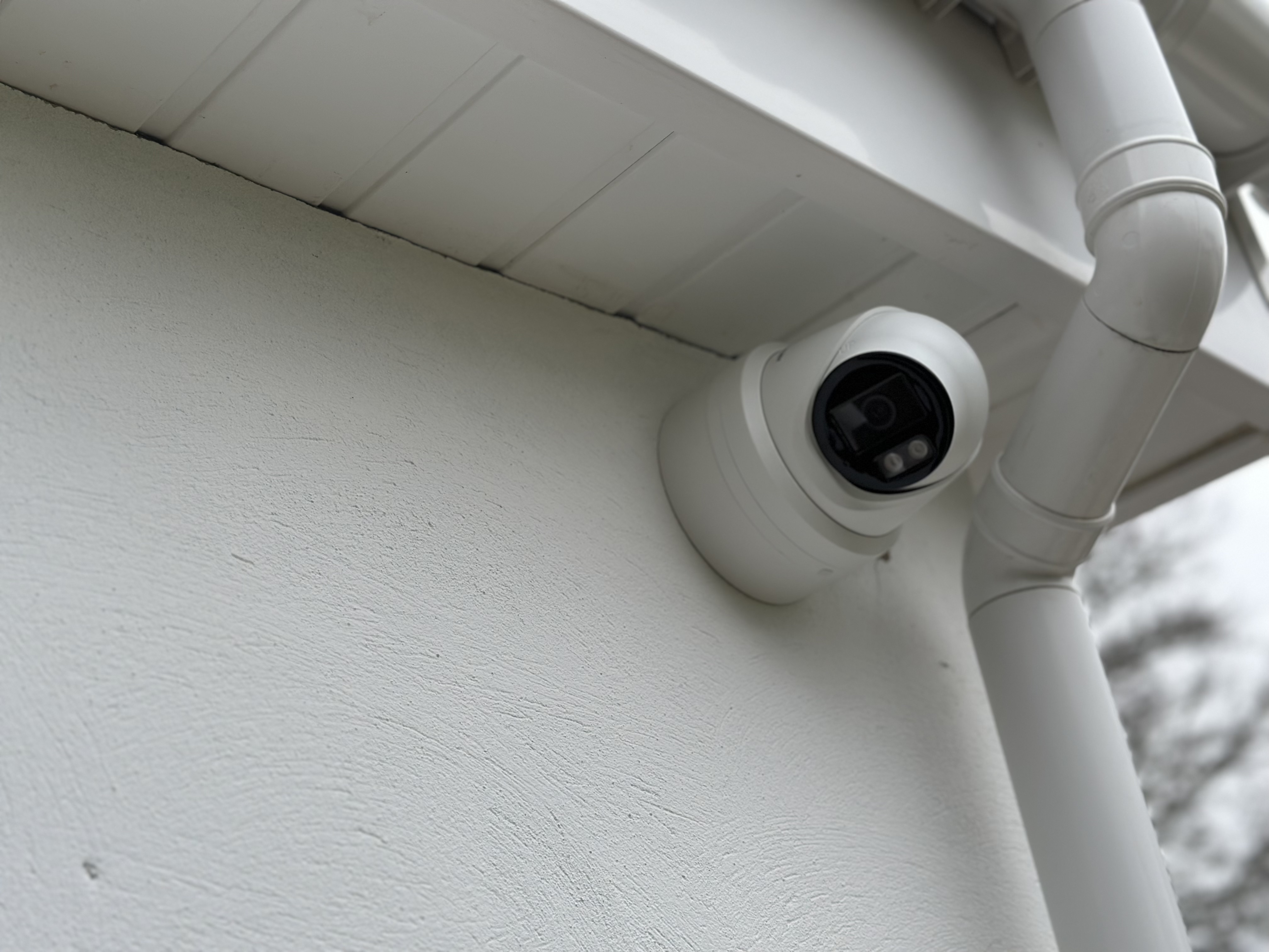 Hikvision turret camera installed beneath an eave