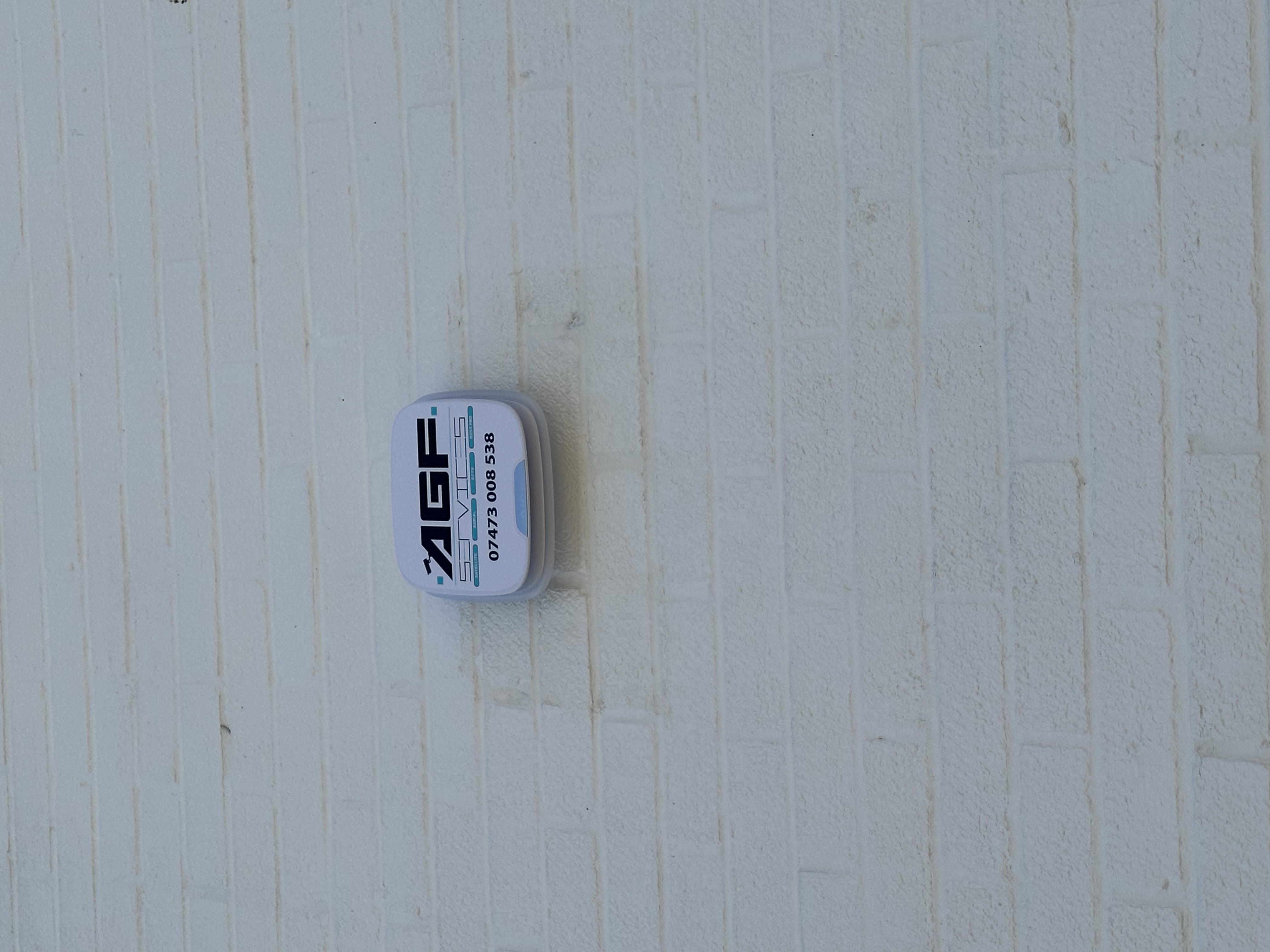 AGF Services external alarm sounder on white brickwork