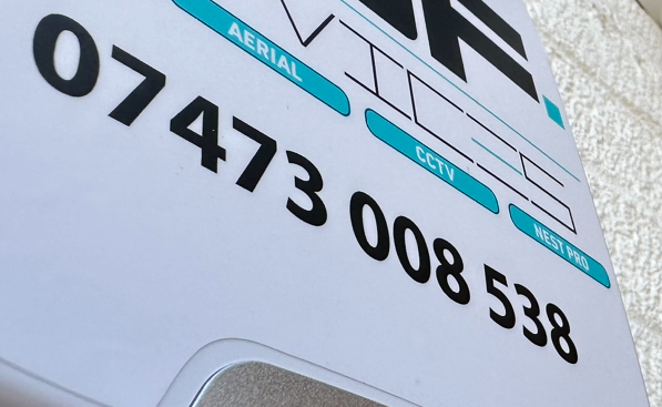 Close-up of AGF Services exterior alarm branding