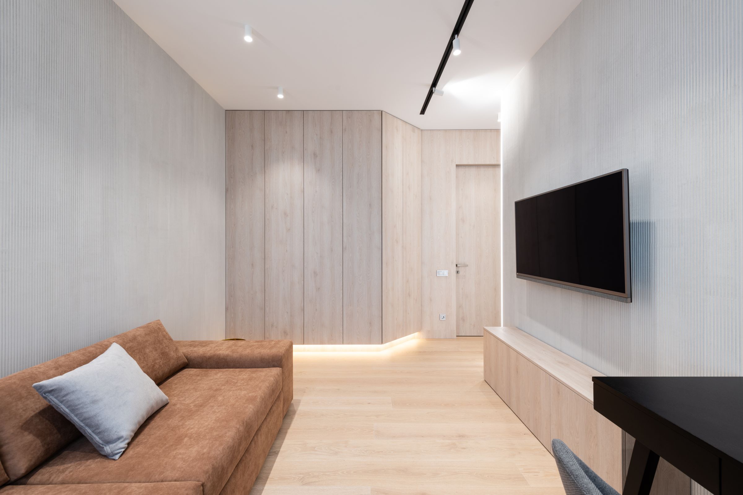 Modern living room with integrated television and considered lighting