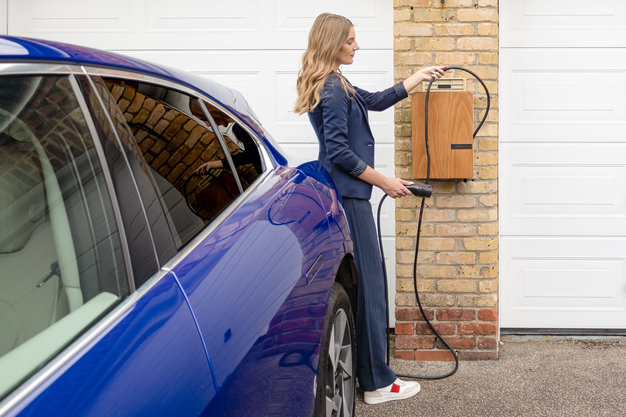 Home EV charger with vehicle connected on a private driveway