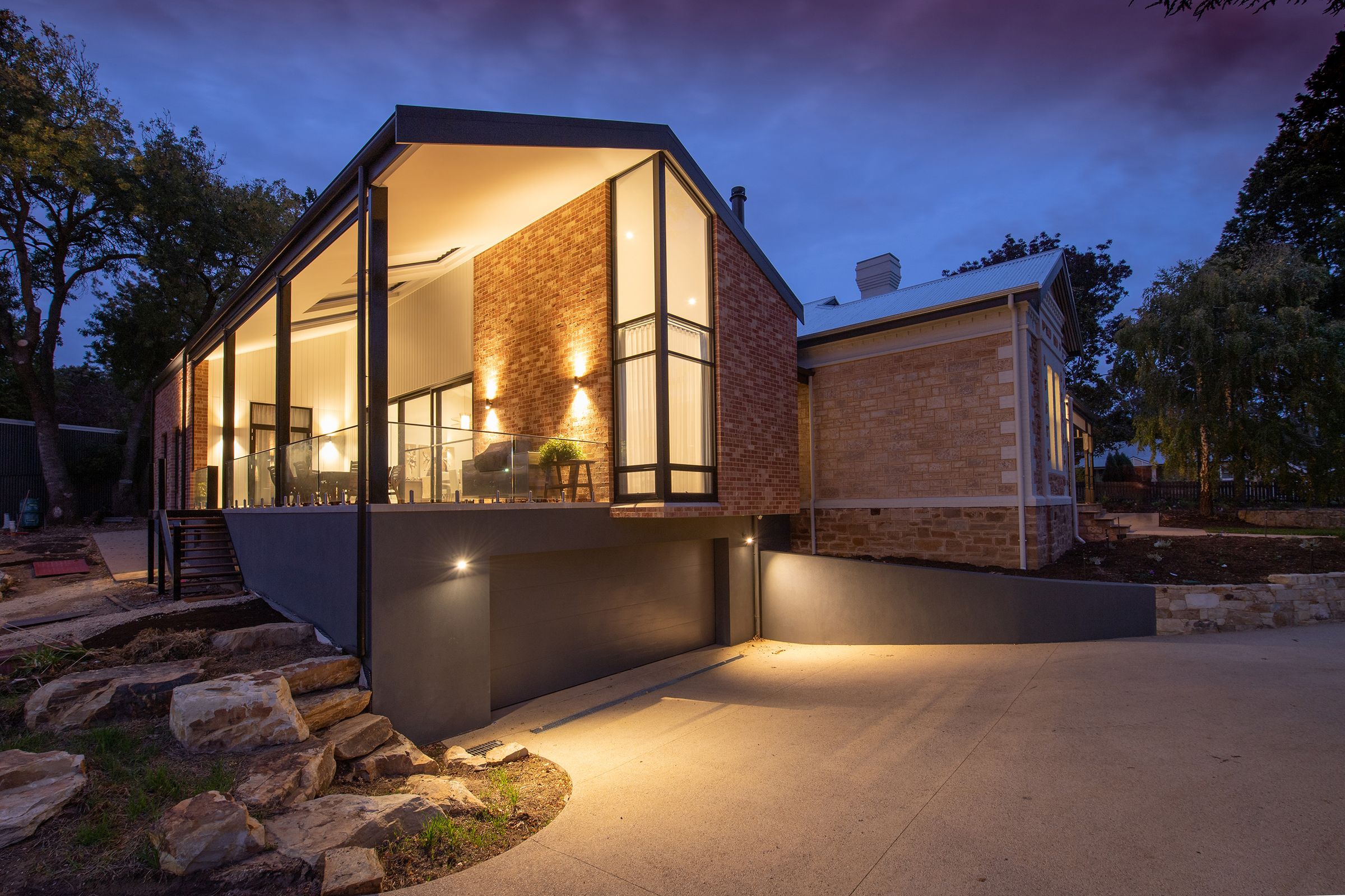 Professionally illuminated modern home at dusk