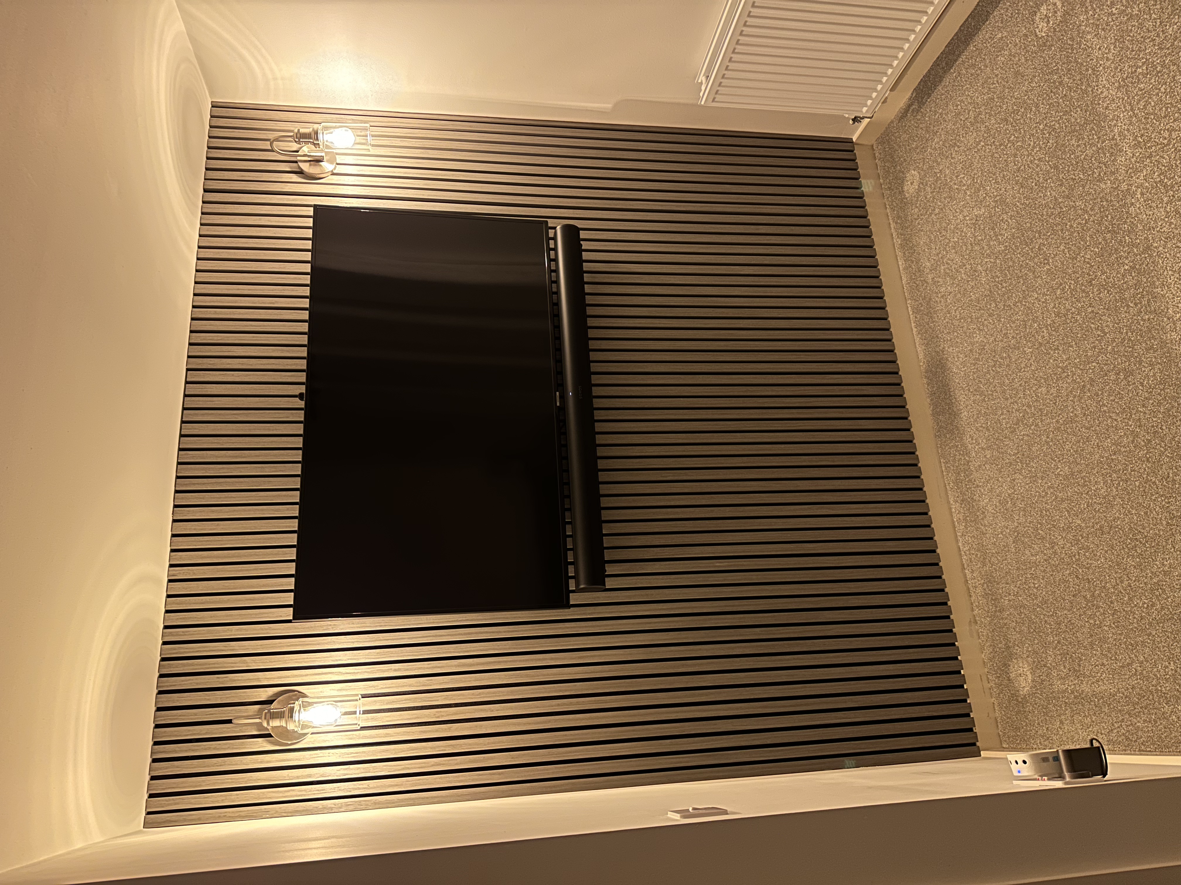 Television mounted on a finished slatted feature wall by AGF Services
